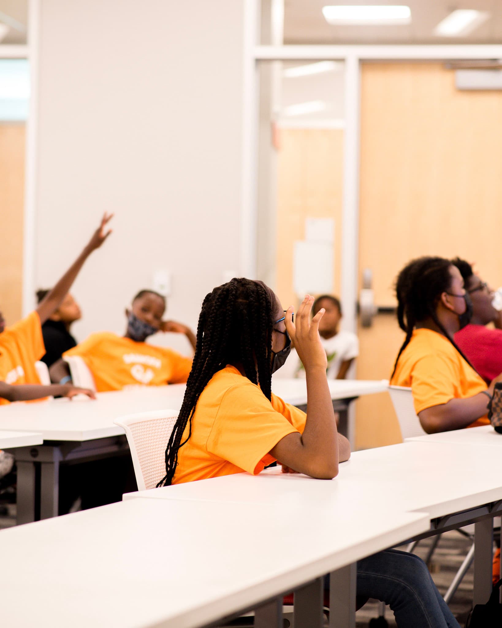 Student asking a question in a classroom